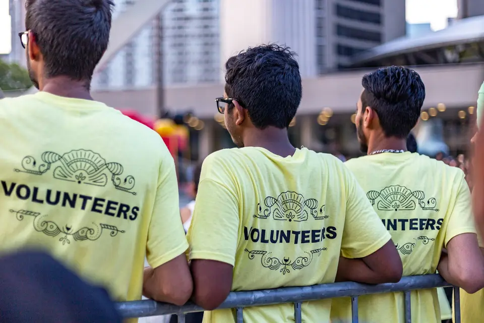 People wearing volunteer t-shirts at a community event