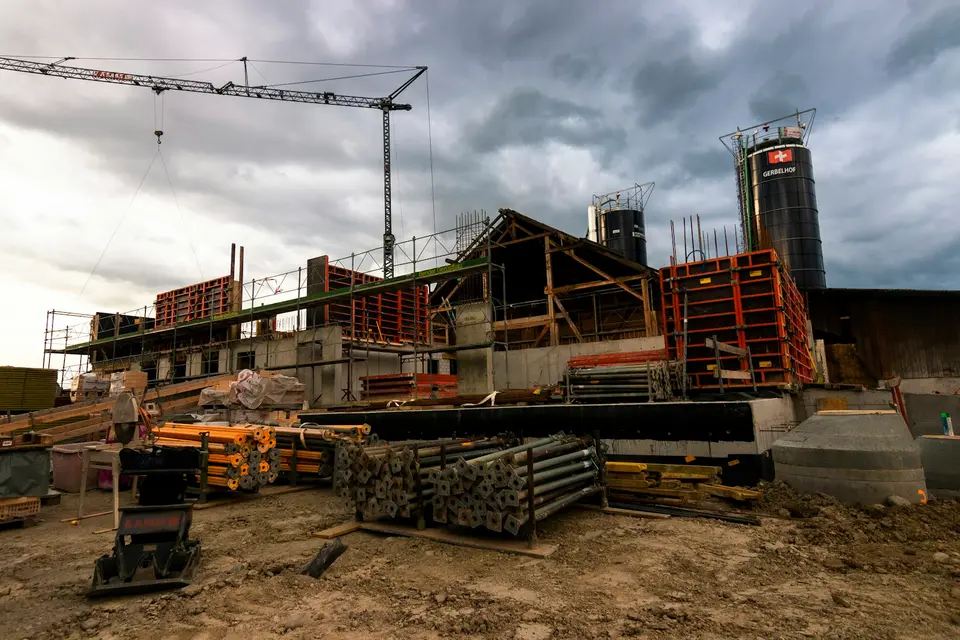 A building under construction with a crane and scaffolding